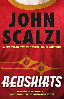 Close up of a red t-shirt with a gold collar. There is a futuristic logo in faded yellow on the chest. Book cover copy reads John Scalzi (in black lettering and Redshirts in white lettering.